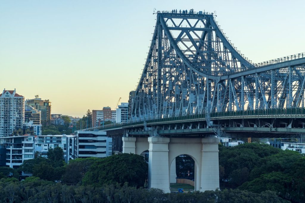 Stunning view of Story Bridge in Brisbane at dusk with city skyline in the background.